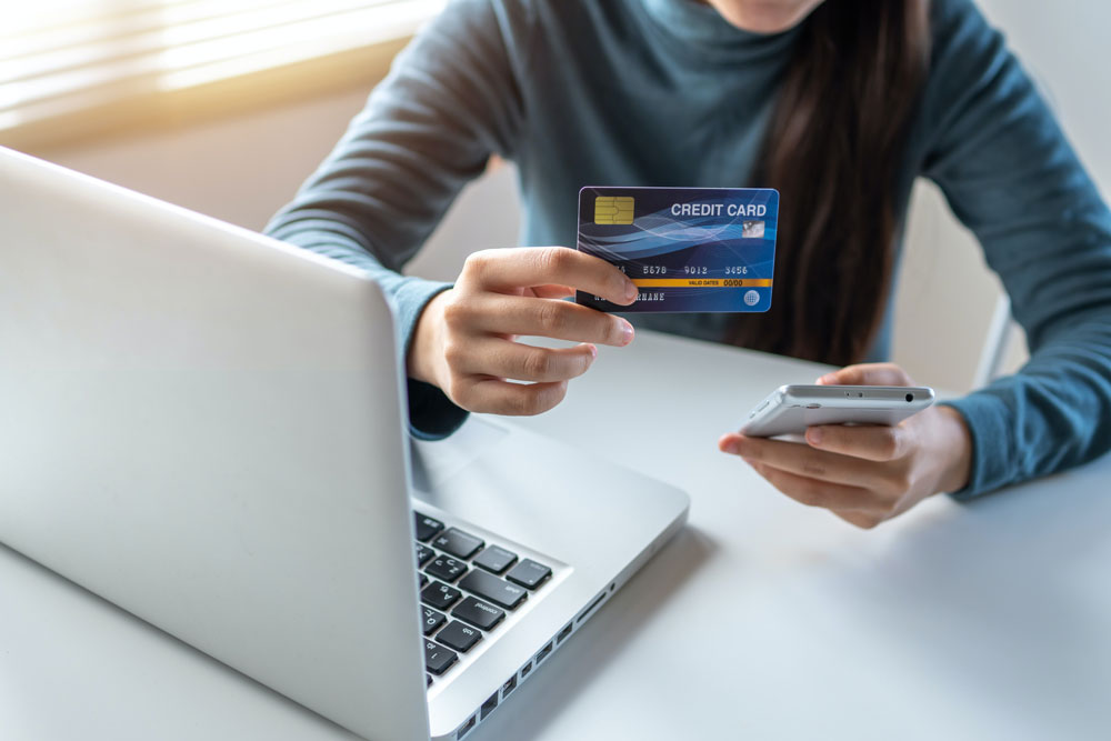 A lady holding credit card on hand